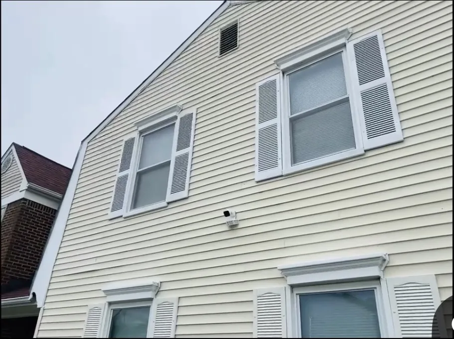 Residential house exterior with light-colored siding